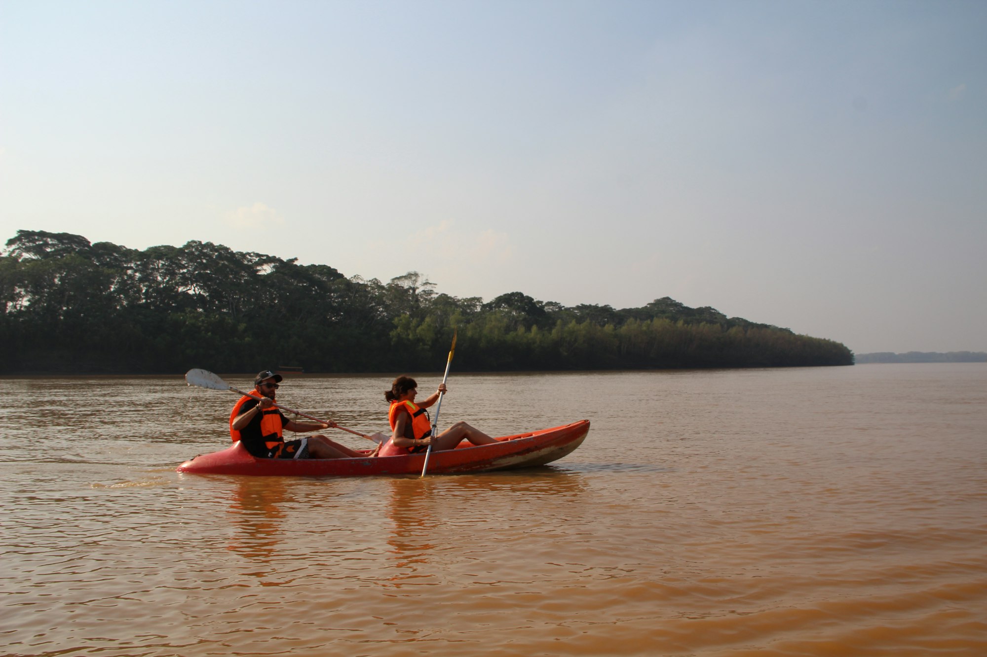 A couple on a canoe ride along the Madre de Dios River in Puerto Maldonado, Peru